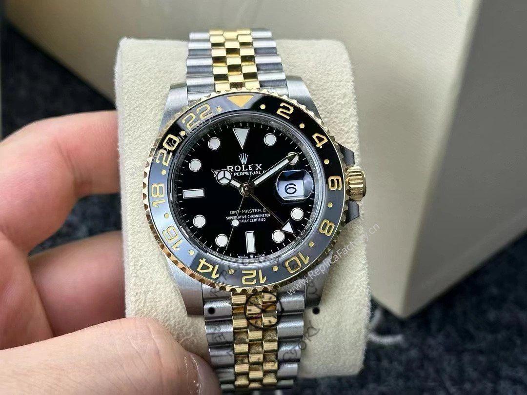 Real photo of Rolex GMT-Master II 126713GRNR-0001 showing black dial, gold bezel, and Jubilee bracelet.